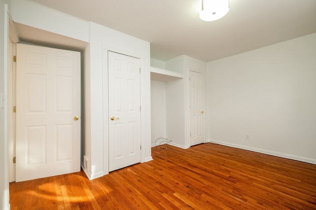 unfurnished bedroom with hardwood / wood-style floors