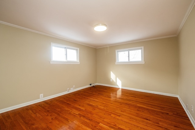 unfurnished room featuring hardwood / wood-style flooring, a wealth of natural light, and ornamental molding