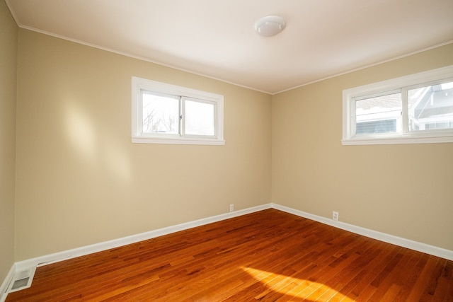 spare room with hardwood / wood-style floors