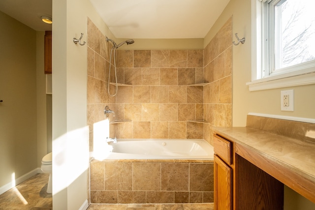 full bathroom featuring vanity, toilet, and tiled shower / bath combo