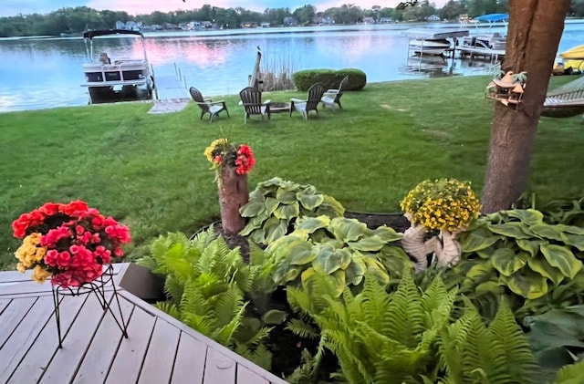 view of yard featuring a boat dock and a water view