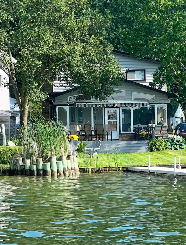 back of house with a water view