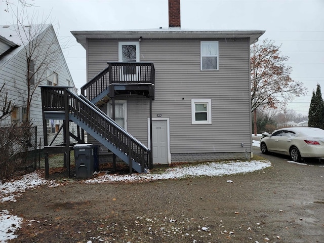 view of snow covered rear of property