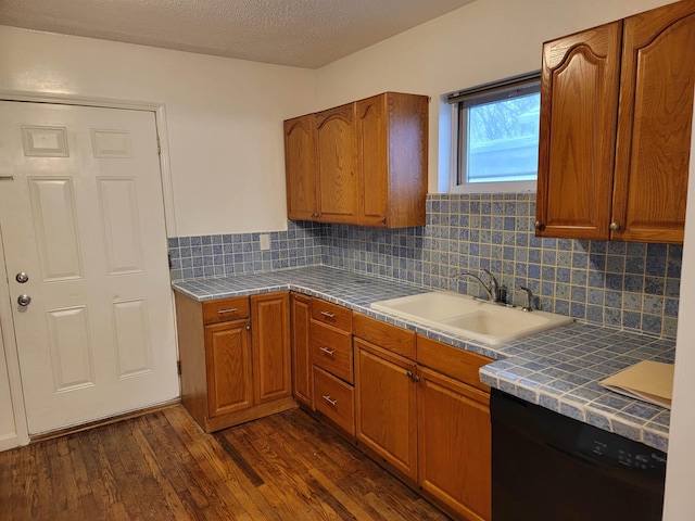 kitchen featuring dishwasher, dark hardwood / wood-style floors, decorative backsplash, and sink