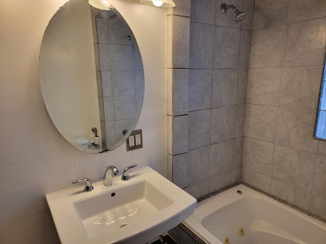 bathroom with sink and tiled shower / bath