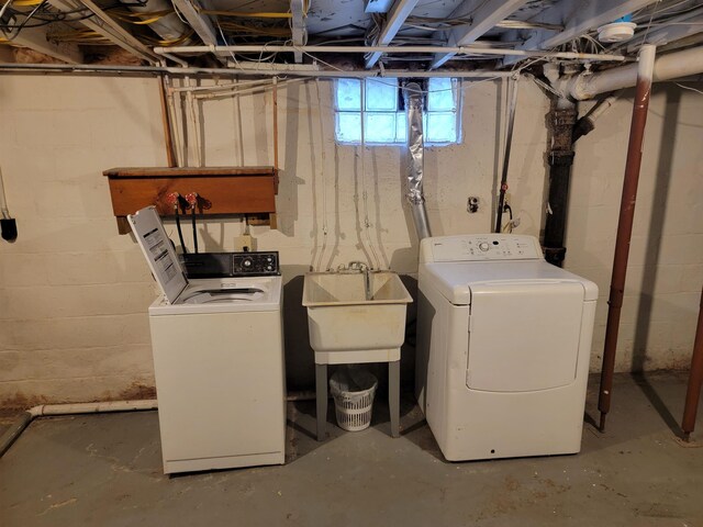 basement featuring washer and dryer and sink