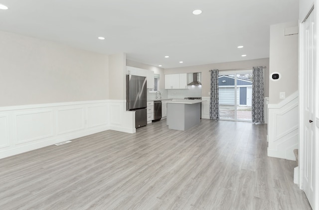 unfurnished living room featuring light hardwood / wood-style floors and sink