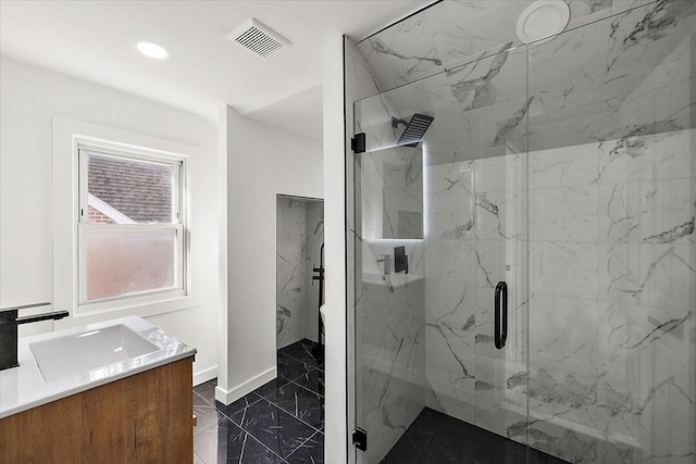 bathroom featuring vanity and a shower with shower door