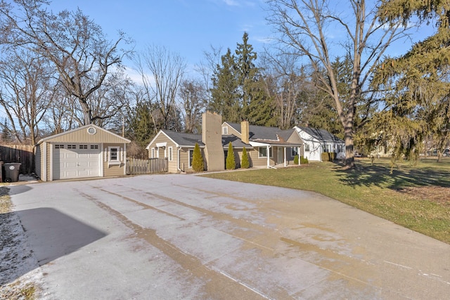 single story home with an outbuilding, a front lawn, and a garage