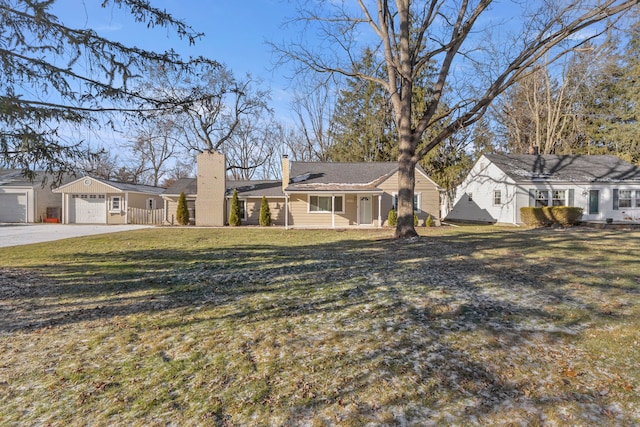 ranch-style house with a front yard and a garage