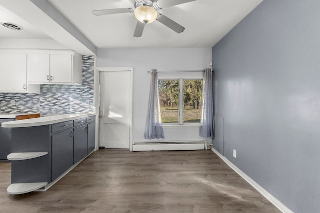 kitchen with ceiling fan, stainless steel dishwasher, a baseboard heating unit, decorative backsplash, and white cabinets