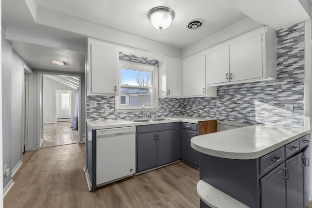 kitchen featuring dishwasher, light hardwood / wood-style floors, white cabinetry, and gray cabinetry