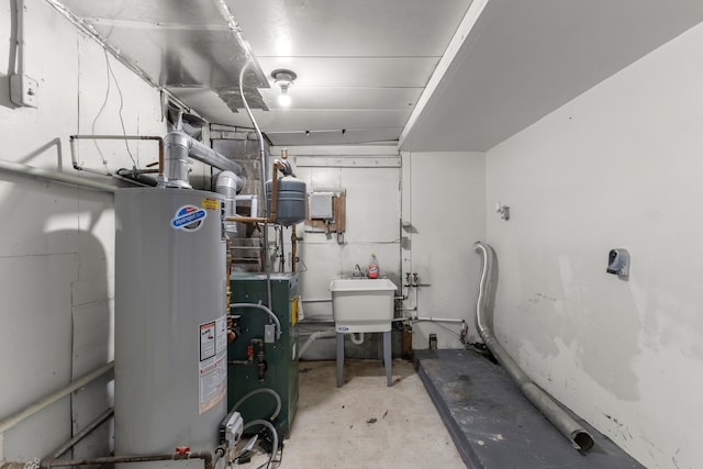 utility room with gas water heater and sink