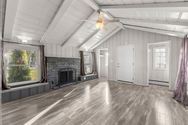 unfurnished living room featuring lofted ceiling with beams, ceiling fan, light hardwood / wood-style floors, and a baseboard heating unit