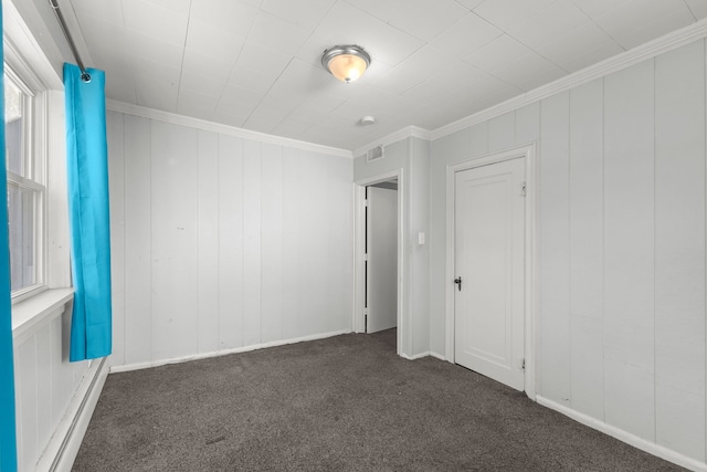 carpeted empty room with crown molding