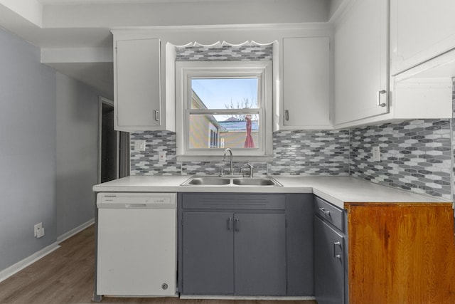 kitchen featuring tasteful backsplash, white dishwasher, sink, white cabinets, and gray cabinets