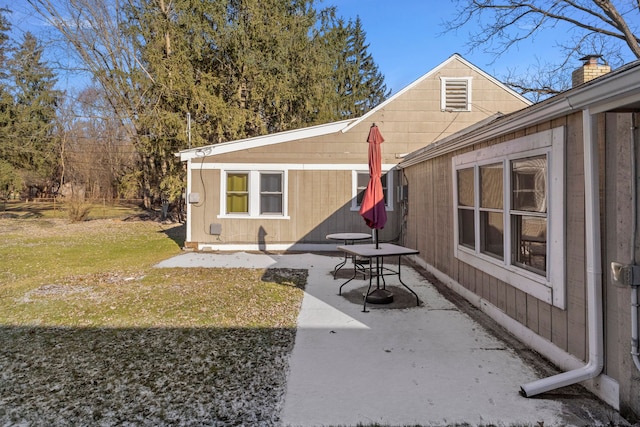 exterior space with a patio and a lawn