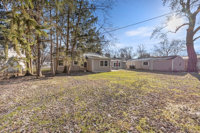 rear view of house with a yard