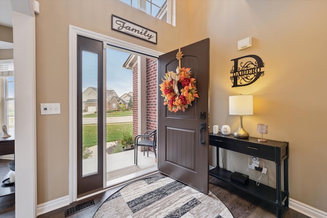 entrance foyer featuring dark hardwood / wood-style floors and a healthy amount of sunlight