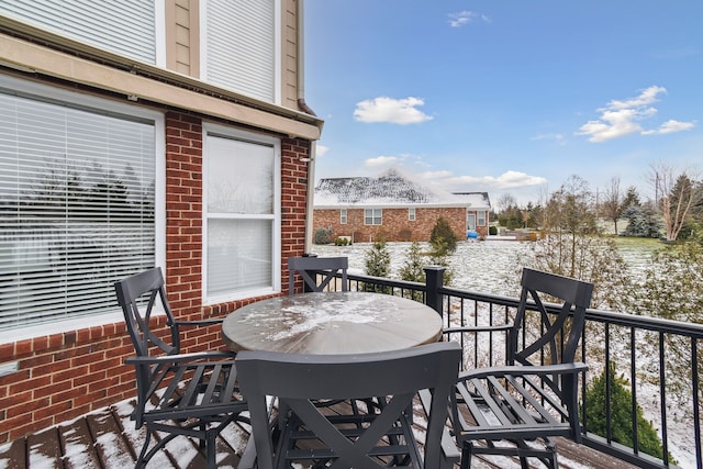 view of snow covered back of property