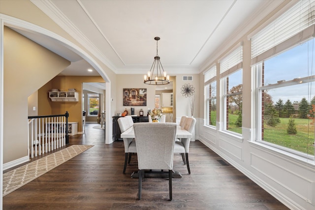 dining room with a notable chandelier, dark hardwood / wood-style floors, and crown molding