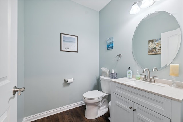 bathroom featuring vanity, wood-type flooring, and toilet