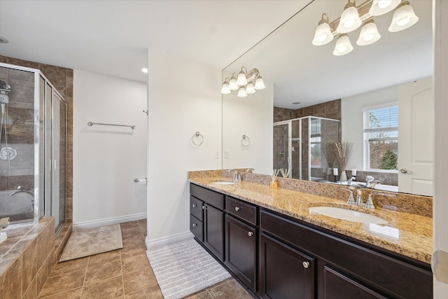 bathroom with vanity, a shower with shower door, and a notable chandelier