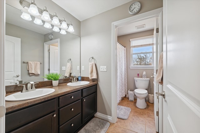 bathroom featuring tile patterned flooring, vanity, and toilet