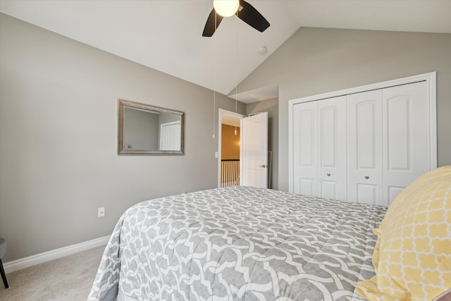 bedroom with carpet flooring, ceiling fan, a closet, and vaulted ceiling