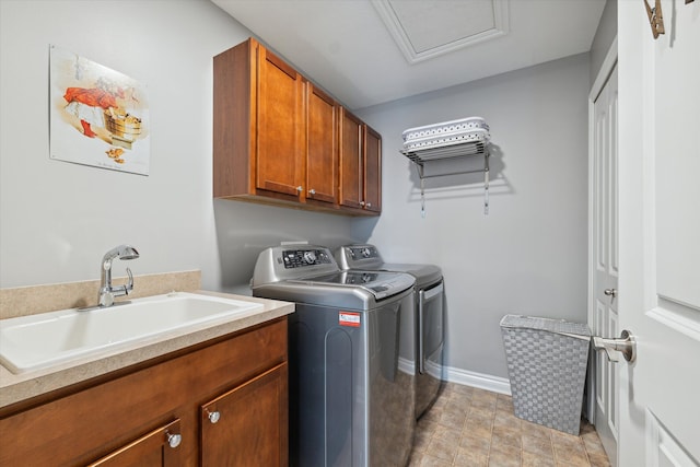 washroom with separate washer and dryer, sink, and cabinets