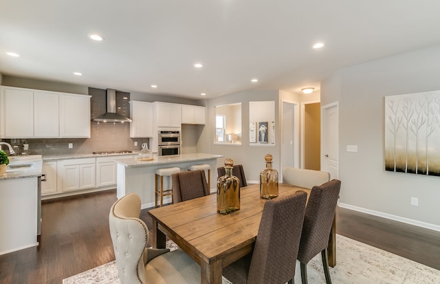 dining room featuring dark wood-type flooring and sink