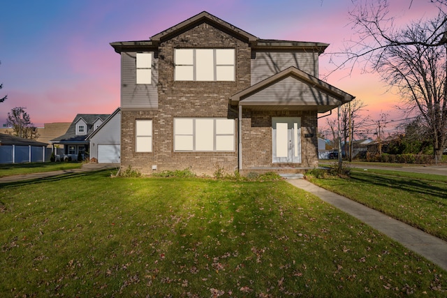 view of front of home featuring a garage and a yard