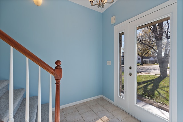 foyer entrance featuring a notable chandelier and light tile patterned floors