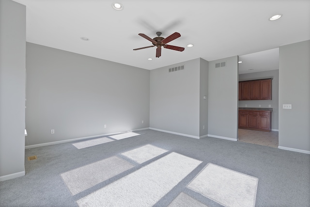 carpeted empty room with ceiling fan