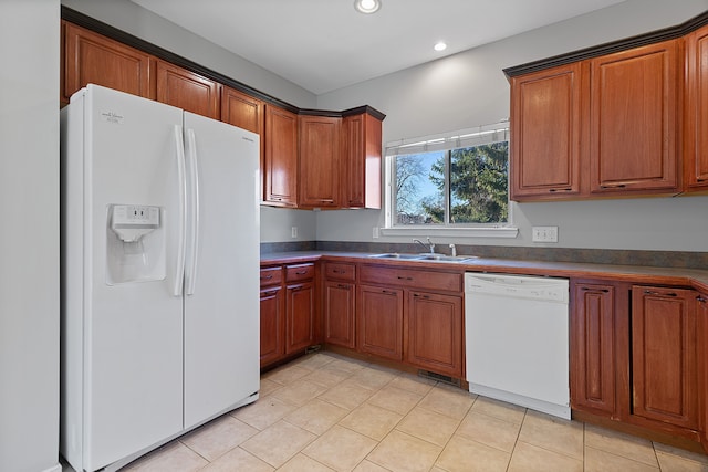 kitchen with sink, white appliances, and light tile patterned floors