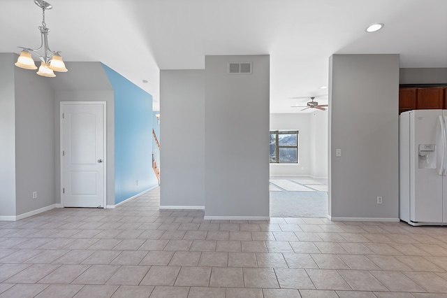 interior space featuring ceiling fan with notable chandelier