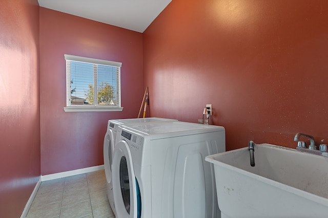 laundry area featuring separate washer and dryer, sink, and light tile patterned floors