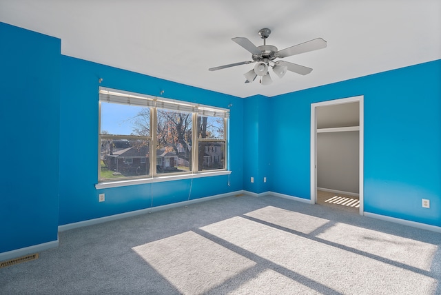 unfurnished bedroom with carpet floors and ceiling fan