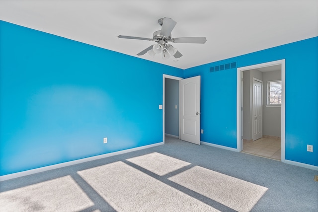 unfurnished bedroom featuring ceiling fan and light carpet