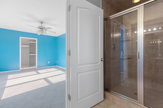 bathroom with ceiling fan and a shower with shower door