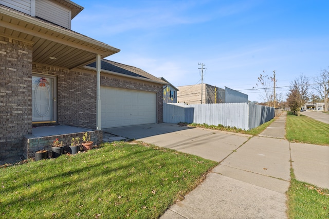 view of home's exterior with a garage and a yard