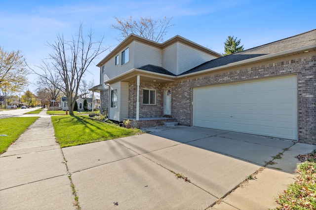 view of front of property featuring a garage and a front yard