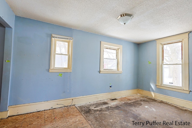 spare room with a textured ceiling