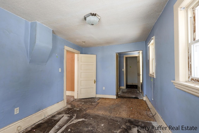 unfurnished room featuring a textured ceiling