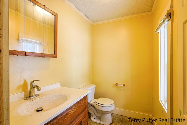 bathroom with a textured ceiling, toilet, vanity, and crown molding