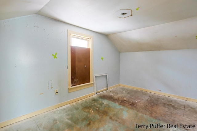 additional living space featuring lofted ceiling