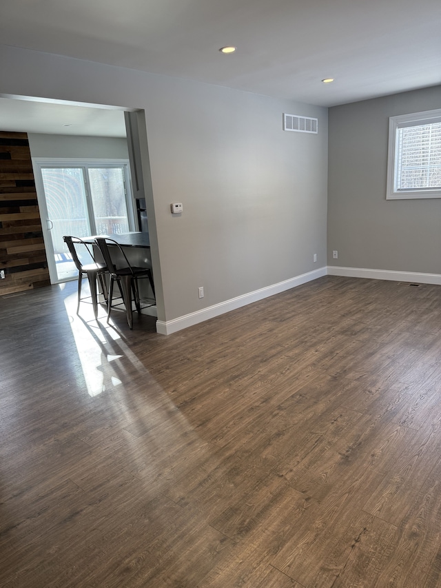 empty room with dark hardwood / wood-style flooring