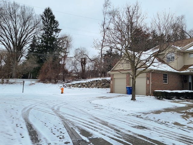 yard covered in snow with a garage