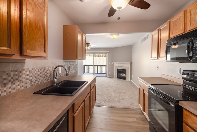 kitchen featuring sink, backsplash, ceiling fan, and black appliances