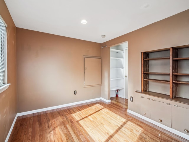 unfurnished bedroom featuring recessed lighting, baseboards, and wood finished floors